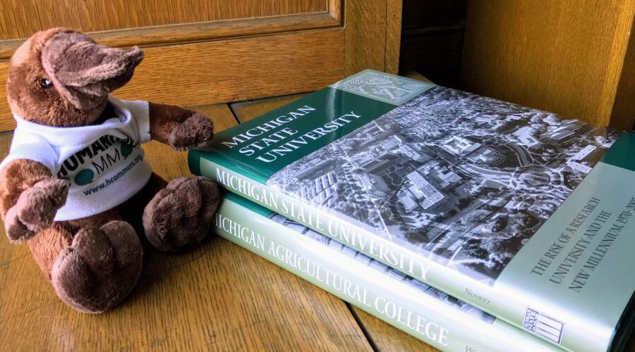 A toy platypus and books about the history of MSU